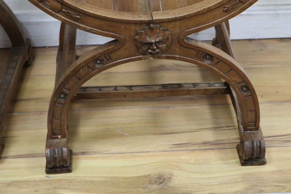 A pair of Italian carved walnut Savonarola type armchairs